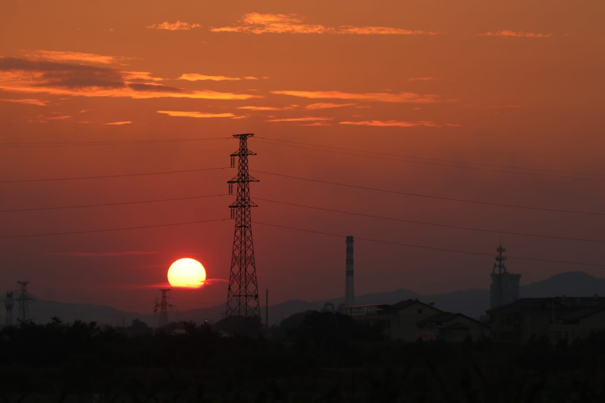 High-voltage transmission tower at dusk